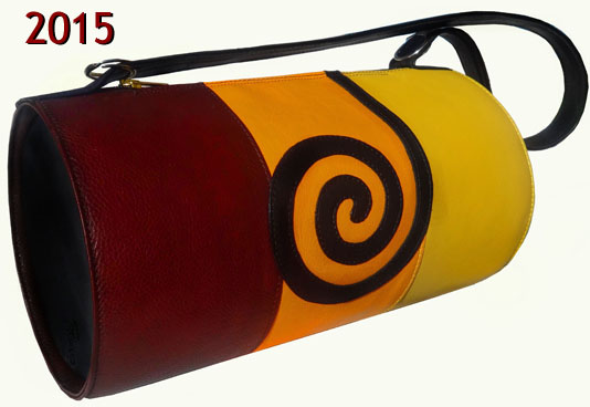 Rjavo-oranžno-rumena torbica v obliki valja